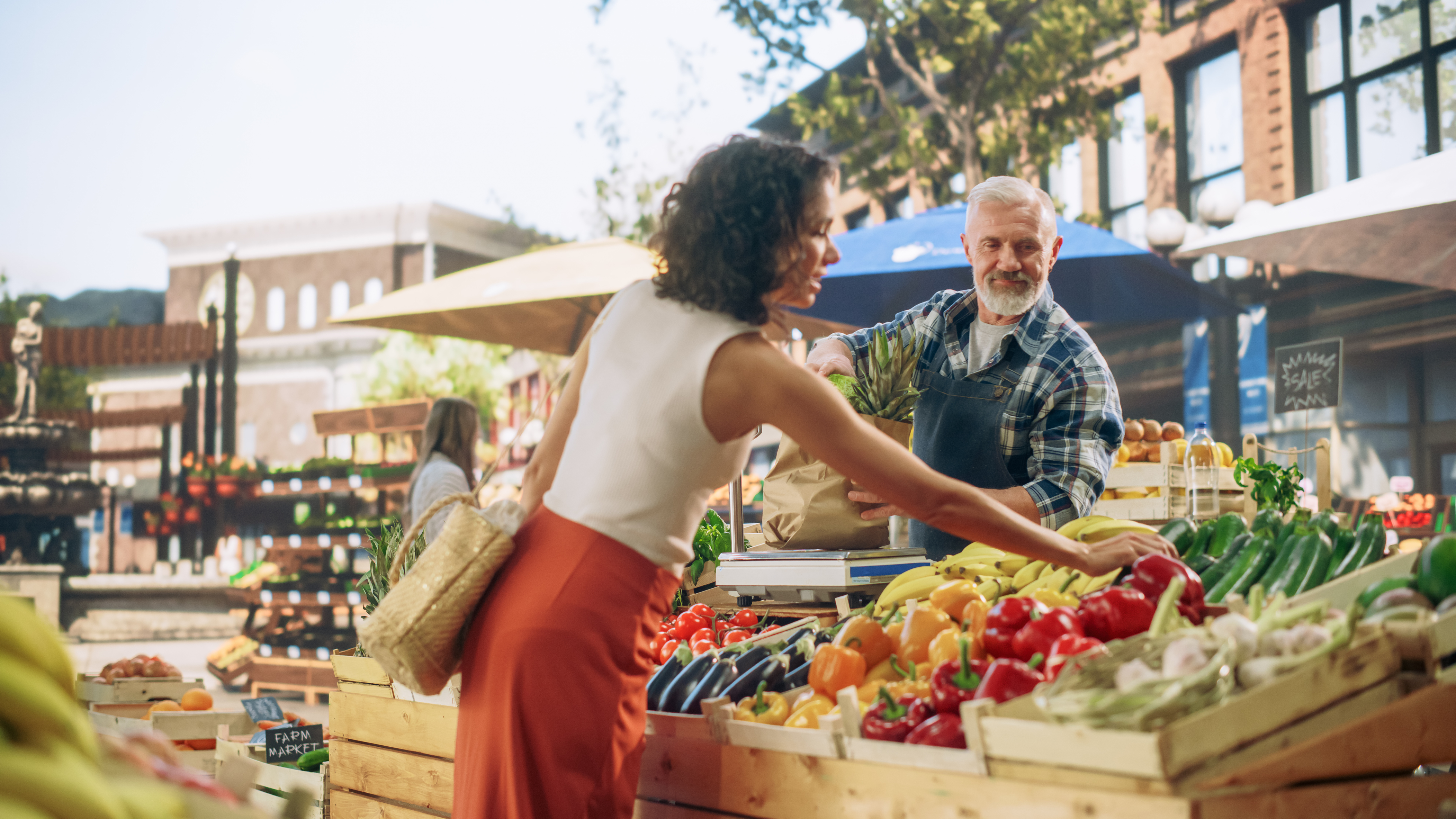 Woman at farmers market selects produce