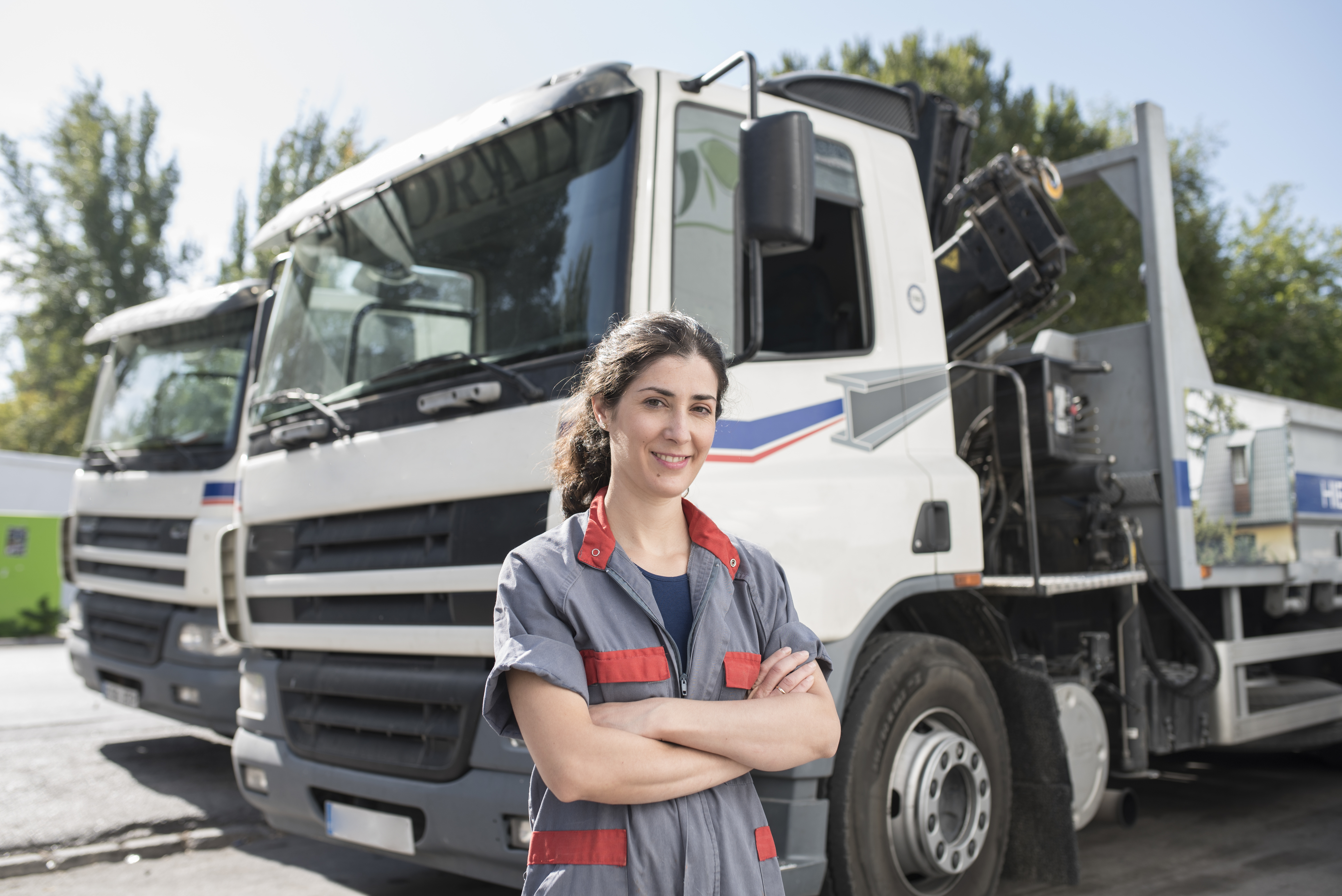 Truck driver standing in front of their vehicle